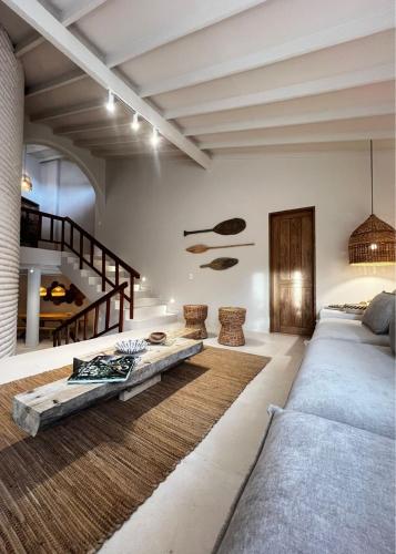 a living room with a couch and a table at Macondo House Private Heated Pool in Medellín
