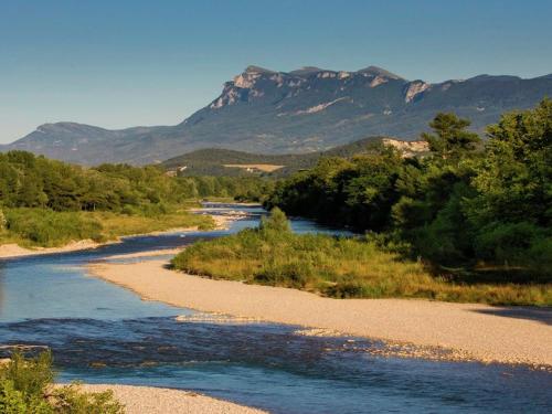 a river with trees and mountains in the background at Mountain View Retreat, Diois in Ponet-et-Saint-Auban