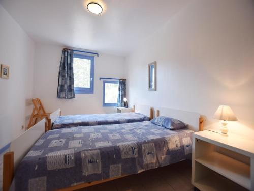 a bedroom with two beds and a dresser with a lamp at Mountain View Retreat, Diois in Ponet-et-Saint-Auban