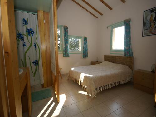 a bedroom with a bed and a window at Mountain View Retreat, Diois in Ponet-et-Saint-Auban
