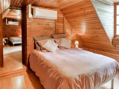 a bedroom with a bed in a wooden room at Tranquil holiday home with private pool in Teillots