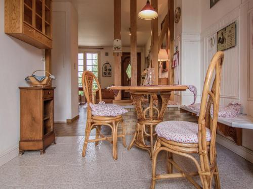 a dining room with a table and chairs at Villa with Pool in Corrèze in Saint-Bonnet-la-Rivière