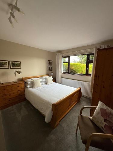 a bedroom with a large bed and a window at Spelga View in Newry