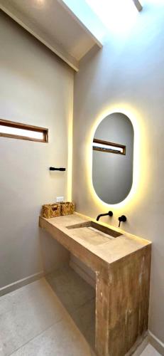 a bathroom with a wooden sink and a mirror at Macondo House Private Heated Pool in Medellín
