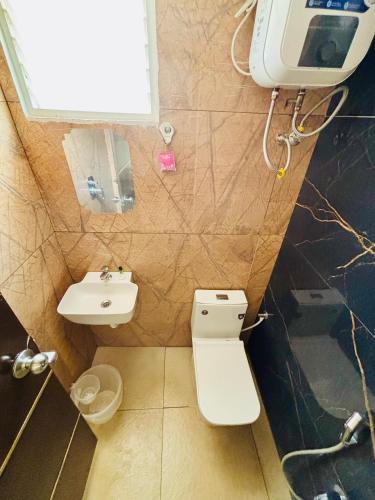 a small bathroom with a toilet and a sink at Courtyard Castle Heritage Resort - Private Villa & Rooms in Pondicherry