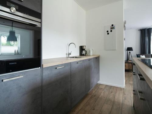 a kitchen with stainless steel cabinets and a sink at Group House in Lemele near Heuvelrug in Lemele