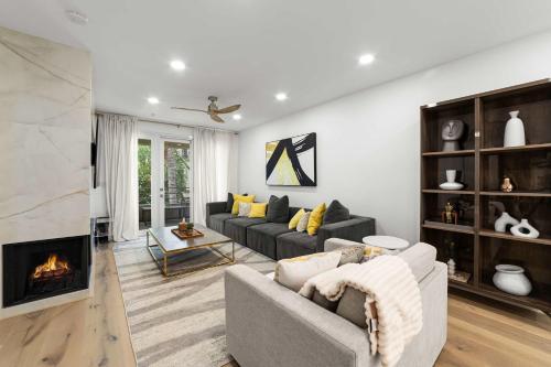 a living room with a couch and a fireplace at Ultra Lux Oasis in Gated Community in Irvine