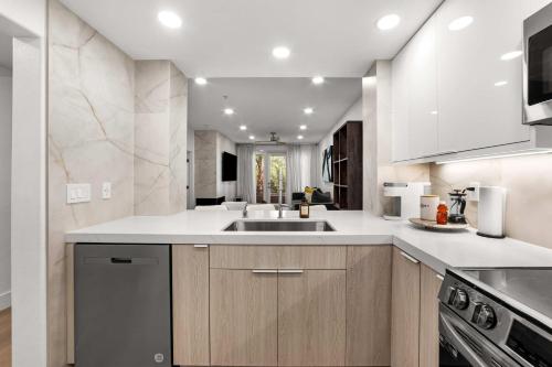 a kitchen with a sink and a dishwasher at Ultra Lux Oasis in Gated Community in Irvine