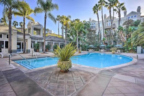 a swimming pool with palm trees and a building at Ultra Lux Oasis in Gated Community in Irvine