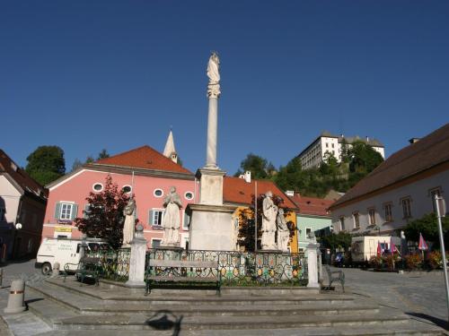 a monument in front of a pink building at Chalet in Stadl an der Mur near Ski Slopes in Stadl an der Mur