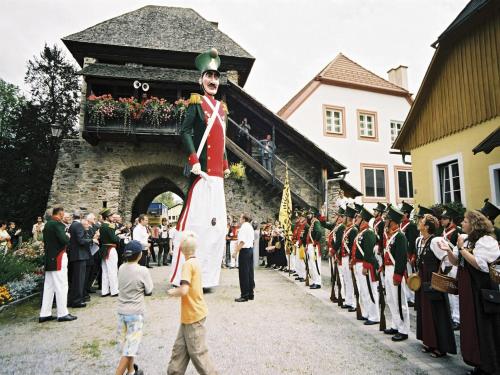 a crowd of people standing around a man dressed in uniform at Chalet in Stadl an der Mur near Ski Slopes in Stadl an der Mur