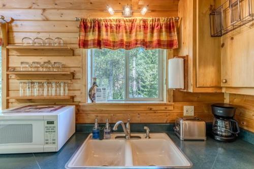 a kitchen with a sink and a microwave at The Aspen House in West Yellowstone