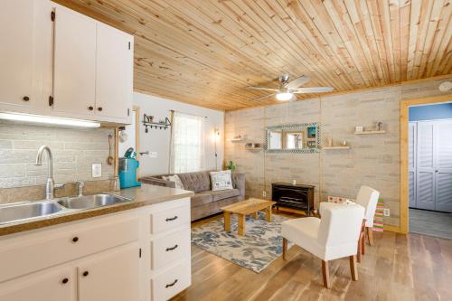 a kitchen with a sink and a living room at Pet-Friendly Mtn Retreat with Yard in Blairsville! in Blairsville