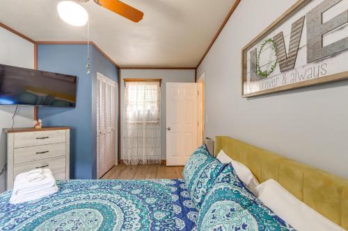 a bedroom with a bed and a flat screen tv at Pet-Friendly Mtn Retreat with Yard in Blairsville! in Blairsville