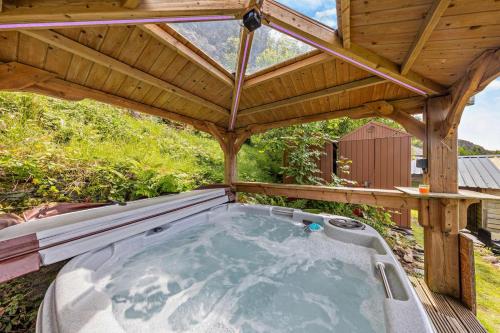 a hot tub under a wooden roof at The Mountains House in Blaenau-Ffestiniog