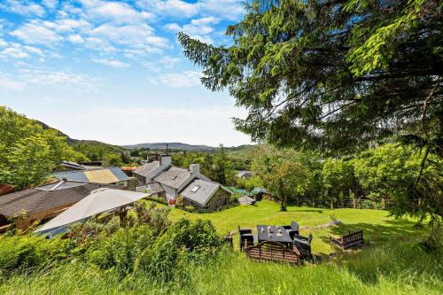 an open field with a group of houses and trees at The Mountains House in Blaenau-Ffestiniog