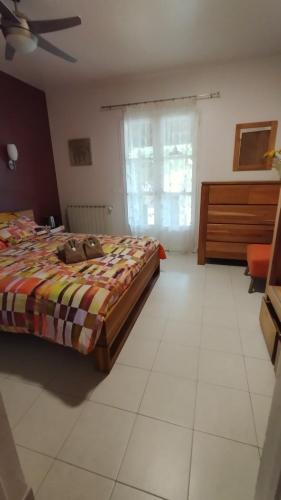 a bedroom with a bed and a dresser at Les Hauts de Cabanoule Générargues in Générargues