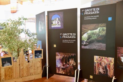 a group of posters on a wall with pictures at Genga Terme Retreat - 1 BR Apt with garden in Genga