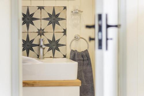 a bathroom with a sink and a towel at Badger Hut in Brampton Bryan
