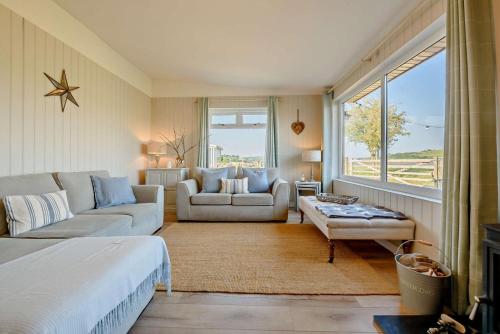 a living room with a bed and a couch and a table at Eryl in Ferryside