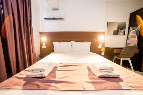 a bedroom with a bed with two towels on it at 1-Bedroom Studio with Stunning Sea & Country View in St Paul's Bay