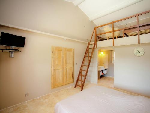 a bedroom with a bunk bed and a ladder at Villa in Provence with Infinity Pool in Martres-Tolosane