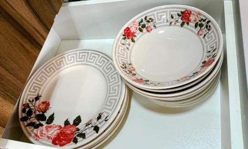 two plates and bowls sitting on top of a table at 8º Relax - Cama de Massagem! in Uberlândia