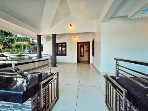 a large room with a pool and a door at Tranquil Nest Villa - 4BHK Villa - Entire Villa stay in Wayanad in Kalpetta