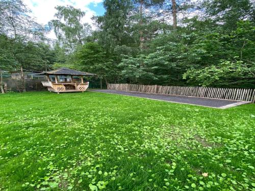 a garden with a gazebo in the middle of a yard at Spacious chalet in Jalhay with jacuzzi in Jalhay