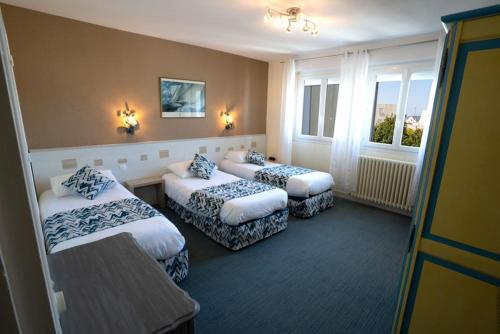 Ένα ή περισσότερα κρεβάτια σε δωμάτιο στο Hotel De La Mer