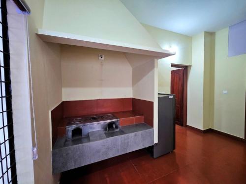 a kitchen with a stove in the middle of a room at Tranquil Nest Villa - 4BHK Villa - Entire Villa stay in Wayanad in Kalpetta