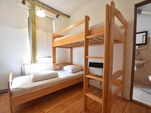 a bedroom with two bunk beds and a bathroom at Holiday Home Abertamy near Ski Slopes in Abertamy