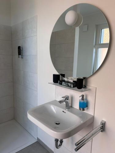 a bathroom with a sink and a mirror at Brommy Apartments in Brake