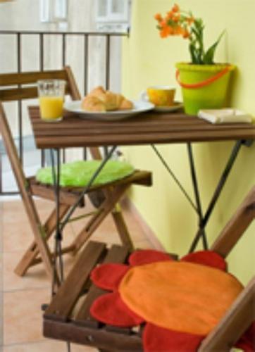 a table with a plate of food on top of it at Fluxus Hostel in Ljubljana