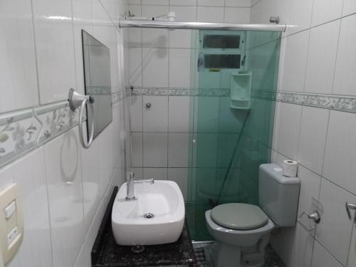 a bathroom with a sink and a toilet and a shower at Residencial Refugio do Mar in Florianópolis