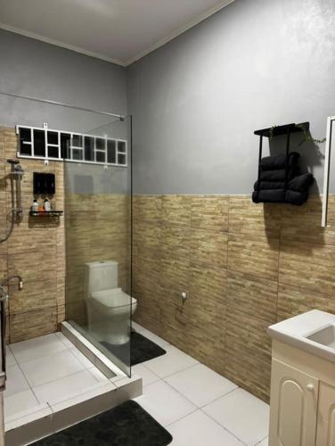 a bathroom with a toilet and a sink at Modern and Stylish Apartment in Courida Park