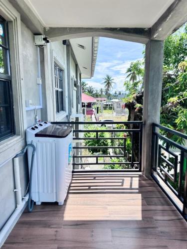 a porch with a washer and dryer on a house at Modern and Stylish Apartment in Courida Park