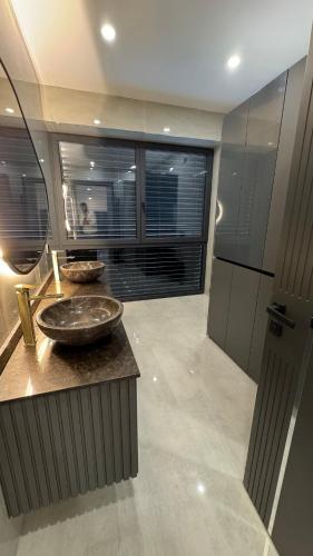 a bathroom with two sinks and a large window at Design-Villa mit privatem Pool, Whirlpool & stimmungsvoller Beleuchtung in Linz