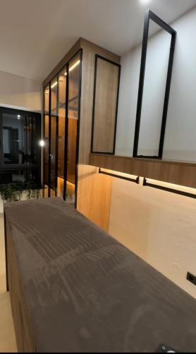 a bedroom with a bed and some glass windows at Design-Villa mit privatem Pool, Whirlpool & stimmungsvoller Beleuchtung in Linz