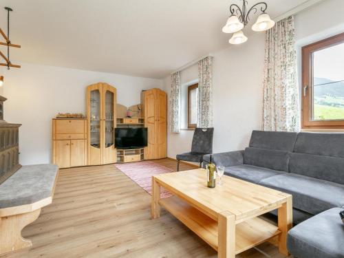 a living room with a couch and a table at Almruhe Alpbach in Alpbach