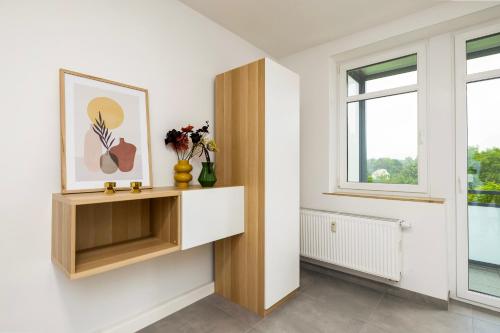a living room with a shelf and a window at NORA Dresden Messe in Dresden