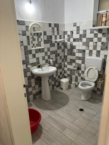 a bathroom with a sink and a toilet at White Marine Hotel in Qeparo