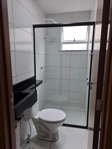 a bathroom with a toilet and a glass shower at AP a 3KM das PRAIAS, com SUÍTE in São Luís