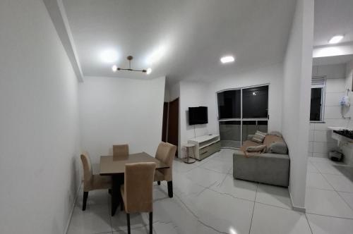 a living room with a table and a couch at AP a 3KM das PRAIAS, com SUÍTE in São Luís