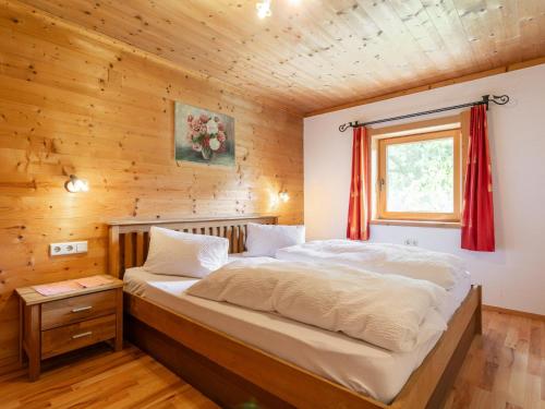 a bedroom with a bed in a wooden cabin at Am Bauernhof Top 2 in Alpbach