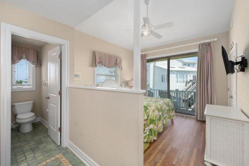 a bedroom with a bed and a bathroom with a toilet at DK290 Point of View in Duck