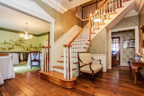 a home with a staircase and a dining room at Virginia Cliffe Inn in Glen Allen