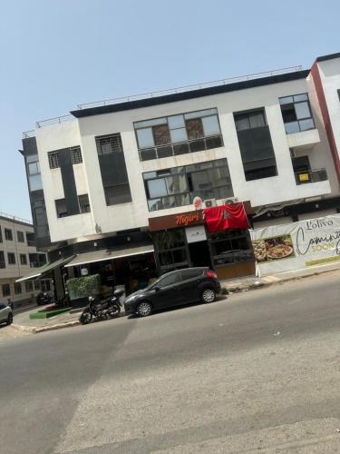 a black car parked in front of a building at Oumhani5 in Sale