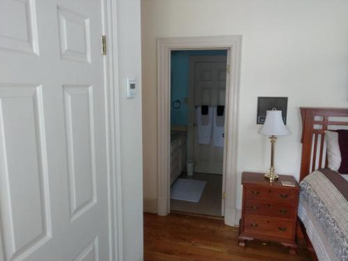 a bedroom with a door leading to a closet at Virginia Cliffe Inn in Glen Allen