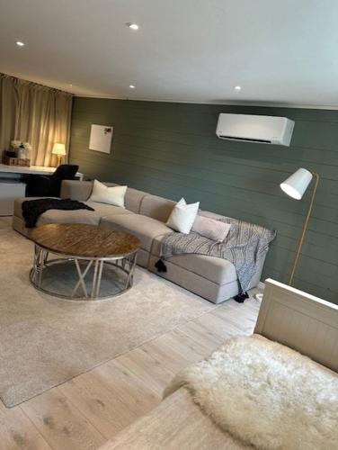 a living room with a couch and a table at Casa de Taira in Sandefjord